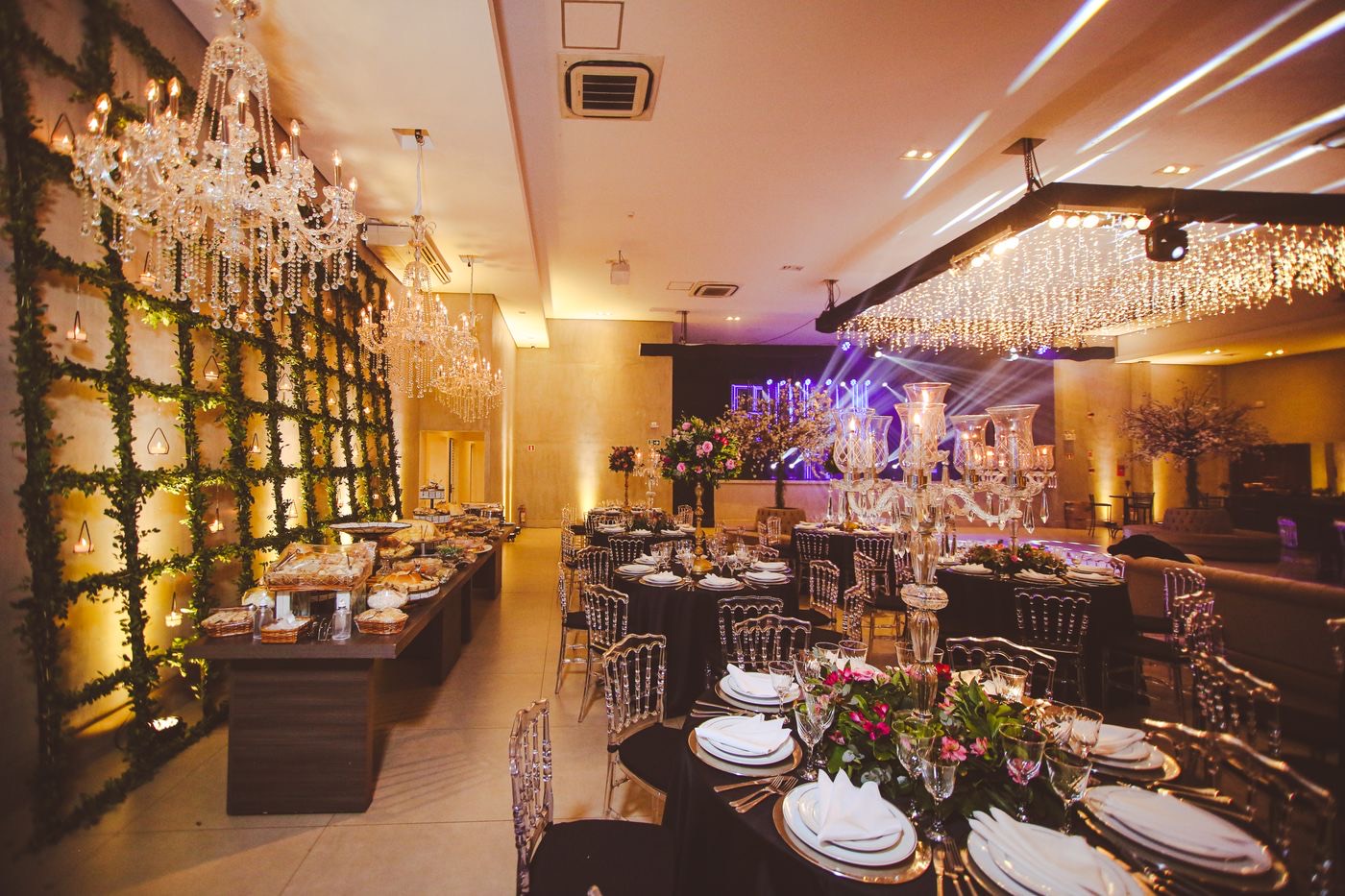 Banquet hall set with chandeliers and floral tables