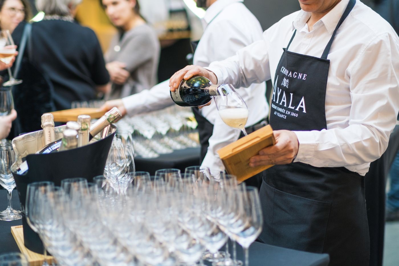 Server pouring champagne at an elegant gathering